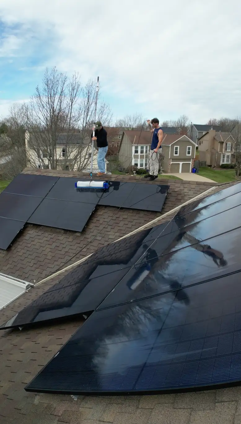 A Solar Scapes crew cleaning residential rooftop solar panels